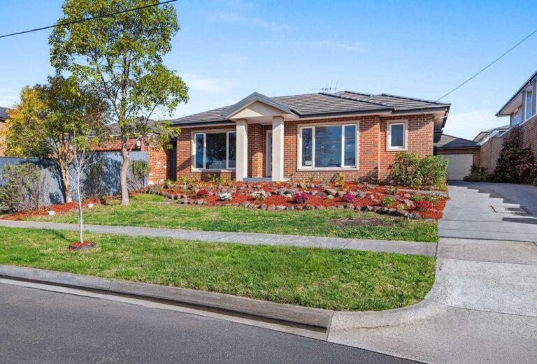 villa unit with brick exterior and neatly landscaped garden.