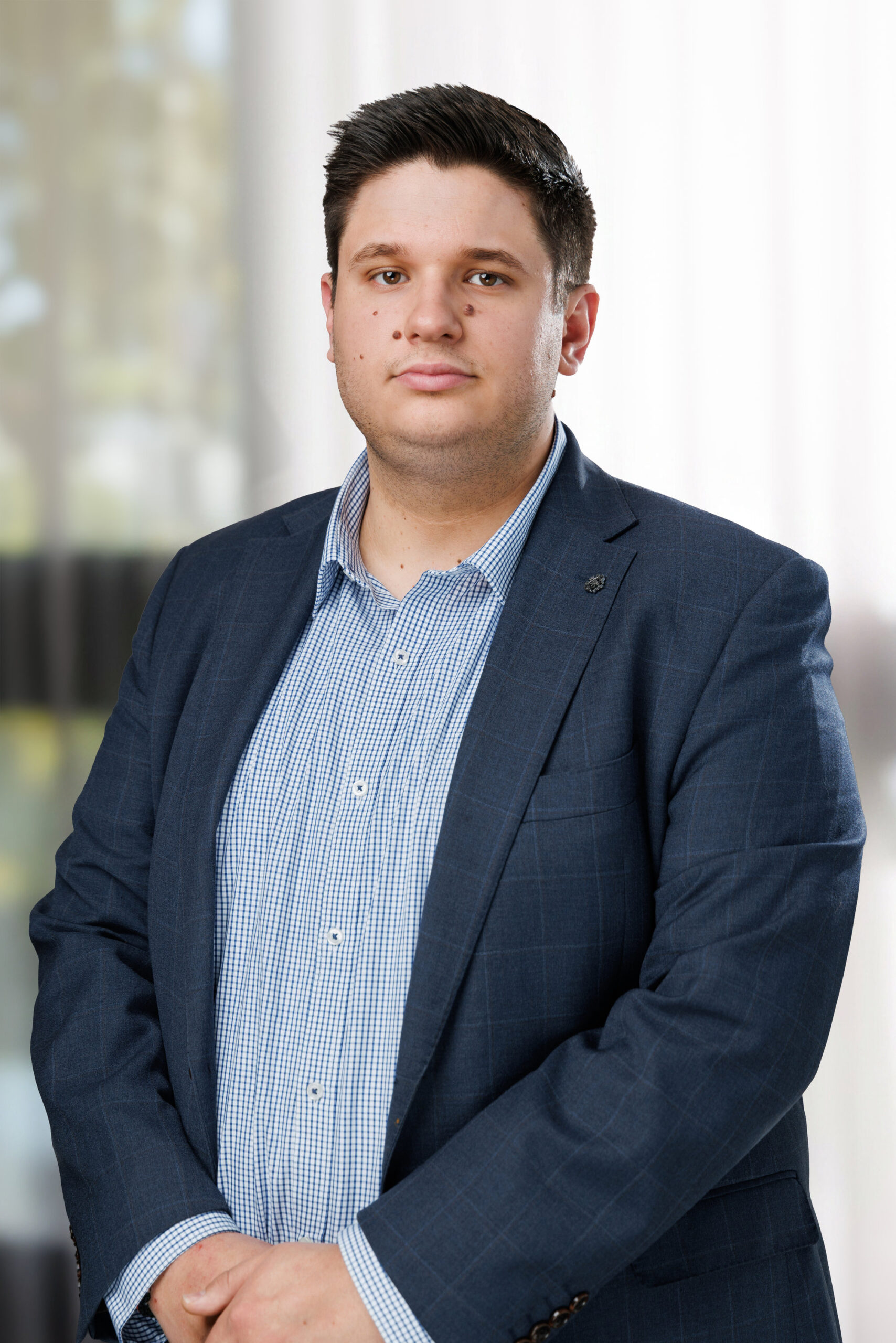 Corporate real estate photo of an agent in a navy blazer